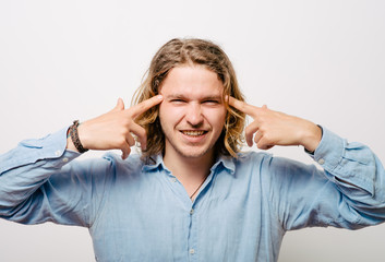 Closeup portrait of angry man gesturing with his finger against his temple, are you crazy?