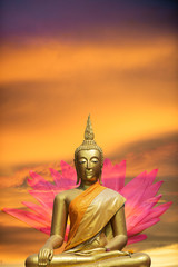 A peaceful superimposed or double exposure images of Golden Buddha statue with a nice background from Ayuthaya, Thailand and a pink lotus. Buddha statue is posing “The attitude of subduing Mara".