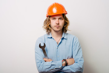 Portrait of young handyman holding a wrench