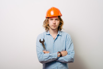 Portrait of young handyman holding a wrench