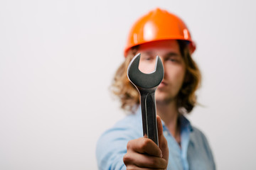 Portrait of young handyman holding a wrench