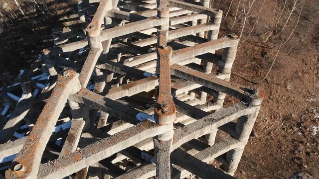 Aerial view protection against mudflow barrier in a gorge in the mountains. Reinforced concrete structure to prevent destruction by natural disaster. Powerful water and mud protection