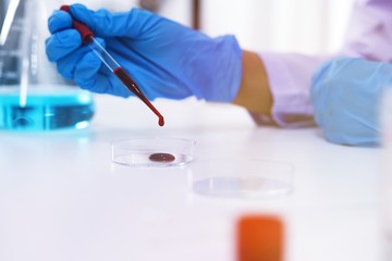 Scientist holding Coronavirus covid-19 infected blood sample tube DNA testing of the blood in the laboratory with blood sample collection tubes and syringe Coronavirus Covid-19 vaccine research.