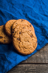 Fresh and healthy cookies with chocolate and seeds on the rustic background. Selective focus. Shallow depth of field.
