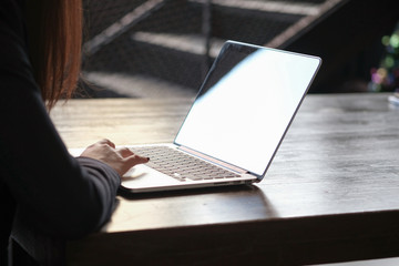 Casual business woman works online on laptop which hand on keyboard in her house Isolated screen in laptop blank white screen.