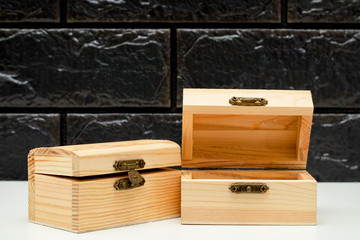 Wooden box with lid on a black background