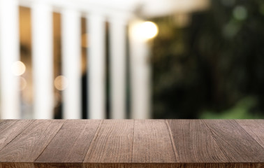 Empty dark wooden table in front of abstract blurred bokeh background of restaurant . can be used for display or montage your products.Mock up for space.