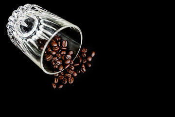 Coffee Beans in glass bottle disrupted isolated on black color