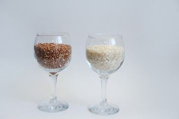 rice and buckwheat groats stand in a wine glass on a white background