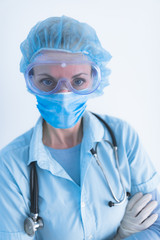 Medical doctor, nurse, surgeon, psychologist working with protective mask, glasses and gloves helping people in the days of panic, pandemic.