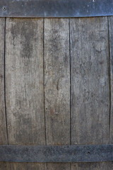 A close up photograph of the side of a barrel.  Old wood and metalwork texture, industrial concept.