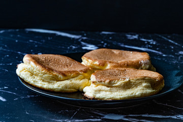 Homemade Plain Fluffy Souffle Pancake in Black Plate Ready to Eat.