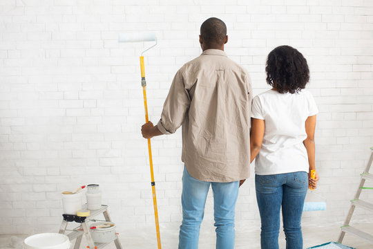 African american couple planning to paint new home interior