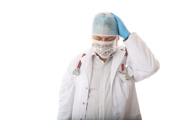 Anguished overworked doctor with head in hands during pandemic