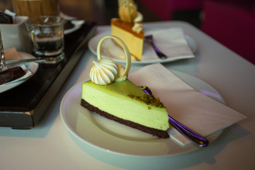 A slice of a lime cheesecake with meringue on top