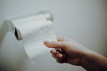 Woman grabbing toilet paper