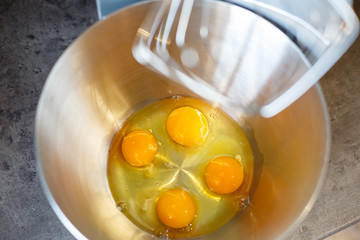 Beating eggs with sugar in a kitchen machine. Cream nozzle