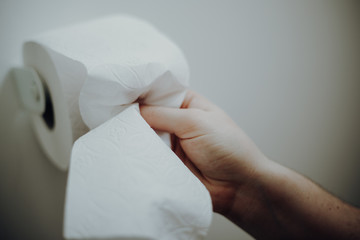 Woman grabbing toilet paper