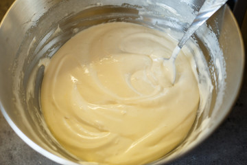 Beating cream for a sweet dessert in a food processor. Cream nozzle