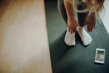 Woman doing home workout on a mat
