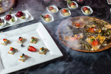 Catering, a table with dishes, a cup with liquid nitrogen, there is a beautiful smoke-2.