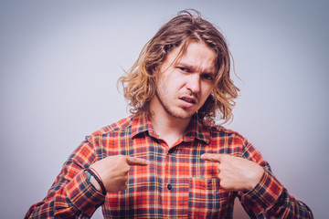 Male hand forefinger pointing to himself on the chest. Gesture. who am i. On a gray background