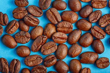 coffee grains from above on a blue background closeup bright HDR
