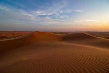 Fototapeta na wymiar Sunset on sand dune in Wahiba sands desert near Bidiyya in Oman