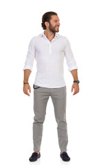 Smiling Handsome Young Man Is Standing Relaxed And Looking Away