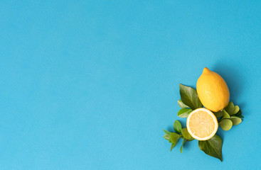 Trendy Summer pattern made with yellow lemon slice on bright light blue background. Minimal summer concept.
