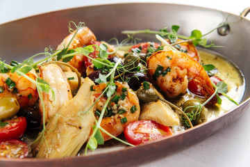 Grilled prawns shrimps with vegetables in a metal bowl, closeup, horizontal