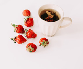 Green tea with strawberries on a white background. Flat lay, top view