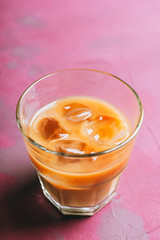 White russian cocktail with ice and cream liquor. Selective focus. Shallow depth of field.