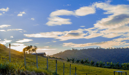 landscape with wooden fence and blue sky