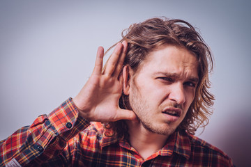 Overhears a man, tries to listen.