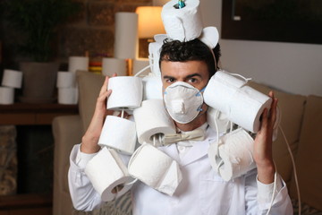 Fashionable man stocking up toilet paper at home