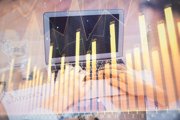 Multi exposure of market chart with man working on computer on background. Concept of financial...