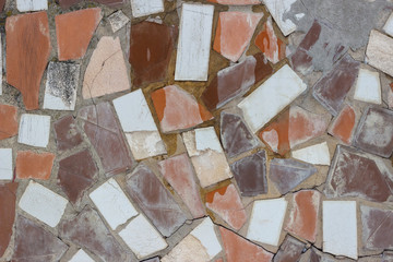 Gray surface made from white and brown rocks with different defects