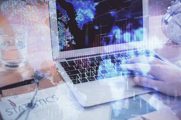Multi exposure of market chart with man working on computer on background. Concept of financial analysis.