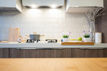 Wooden table top on blur kitchen room background. For displaying the assembly product or visual arrangement of the configuration keys