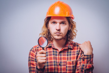 builder with magnifying glass