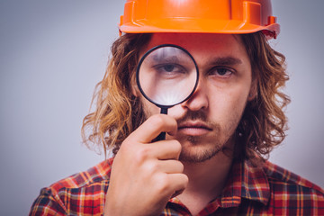 builder with magnifying glass