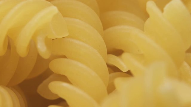 Food background Elegant Pasta Dish. Golden Raw Fusilli pasta macro shot