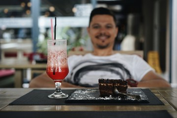 man drinking cocktail at bar