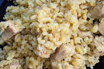 Close up of bulgur cooked with chicken fillet. Healthy diet lunch or dinner. Cereals from durum wheat for weight loss