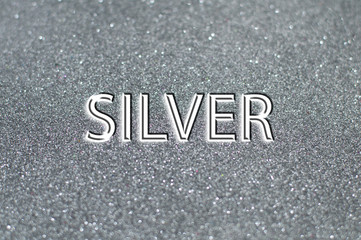 Silver text on gray shiny background.