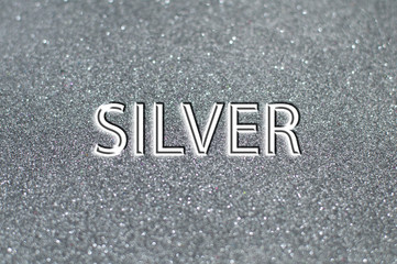 Fototapeta premium Silver text on gray shiny background.