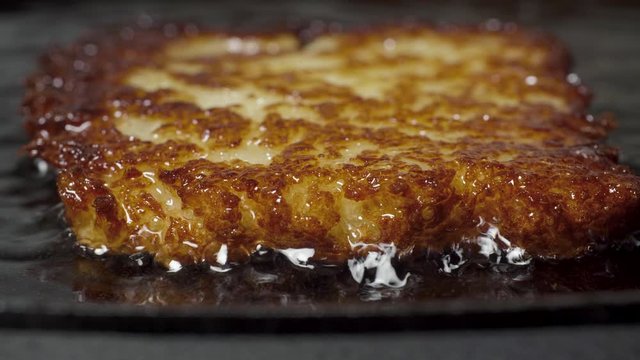 Traditional Belarussian potato pancakes draniki are fried in vegetable oil in a pan