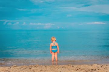 Fototapeta na wymiar little girl go swim on beach vacation