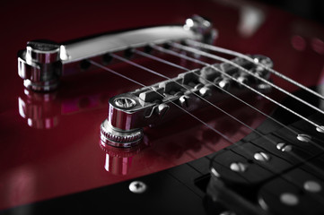 Red electric guitar closeup  on black background